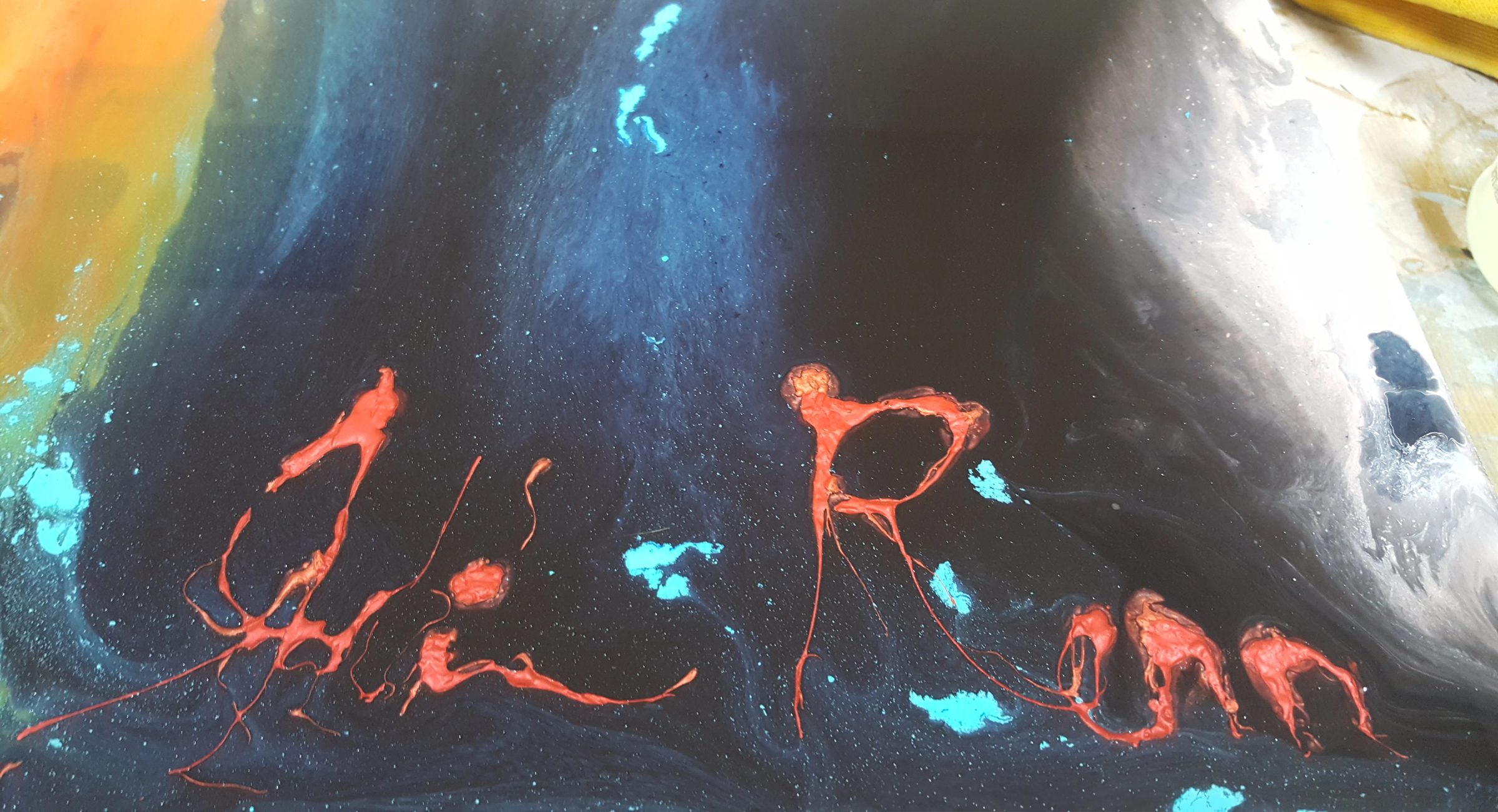 Evolution by Joline Renn — The signature, poured in red