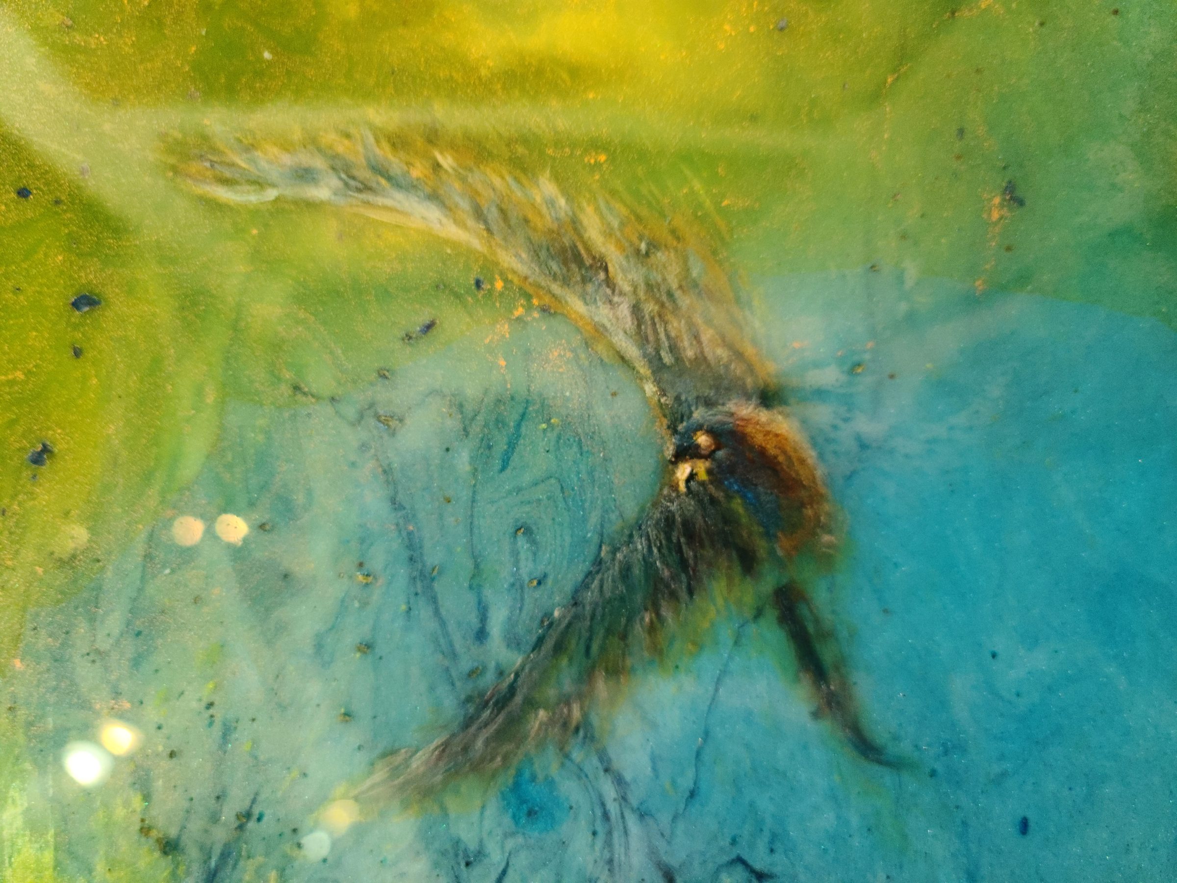 Peacock Spirit by Joline Renn — The peacock taking shape in the pour — feathered edges form where the pigment finds its own way through the resin.